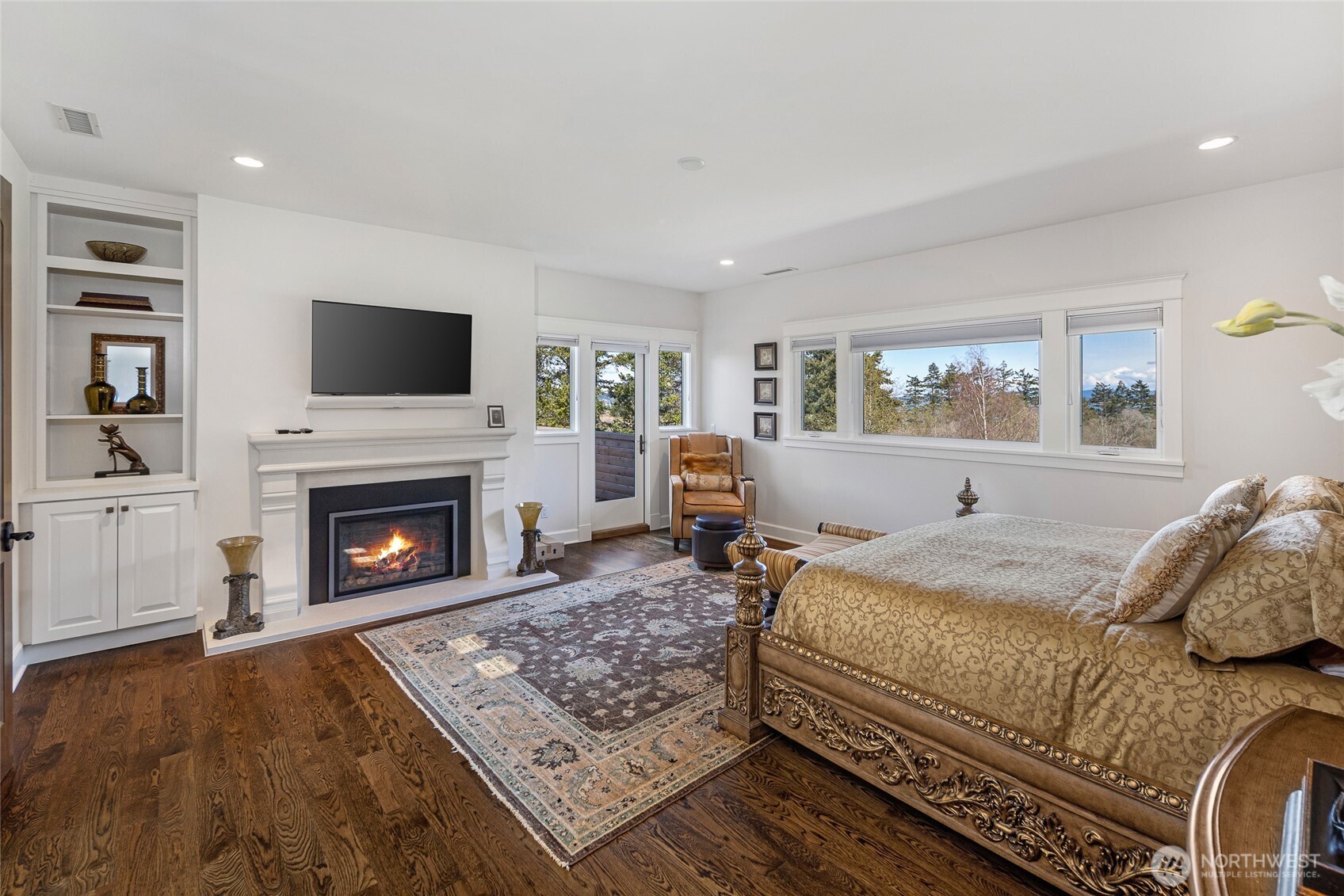 735 Rosler Road San Juan Island, WA 98250 - Photo 21 of 40 a bedroom with a bed and a fireplace