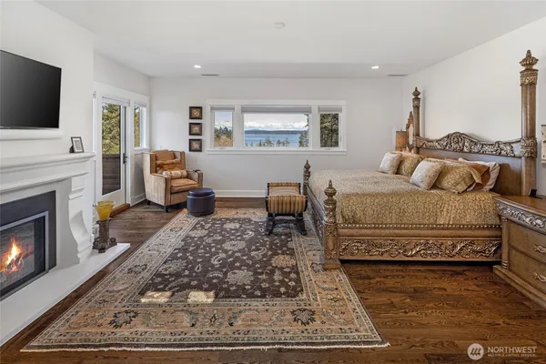 a spacious bathroom with a granite countertop tub a double vanity sink and a large mirror