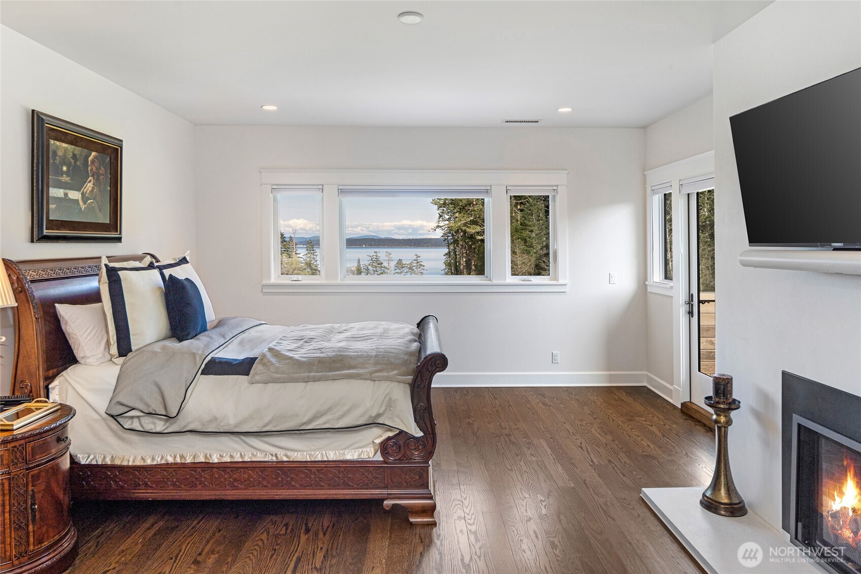 735 Rosler Road San Juan Island, WA 98250 - Photo 28 of 40 a bedroom with a bed and a flat screen tv