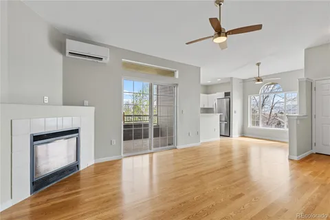 a view of empty room with wooden floor and fireplace