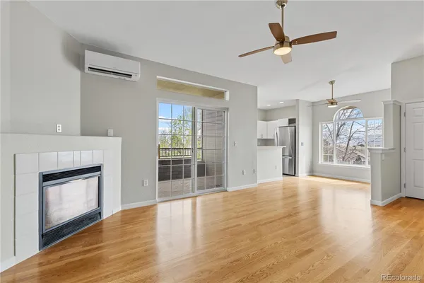 a view of empty room with wooden floor and fireplace