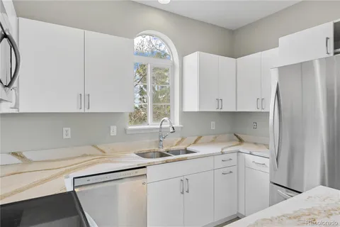 a kitchen with a sink cabinets and window