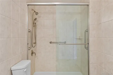 a bathroom with a shower and toilet