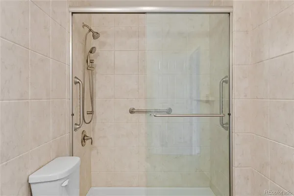 a bathroom with a shower and toilet