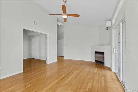 a view of an empty room with wooden floor