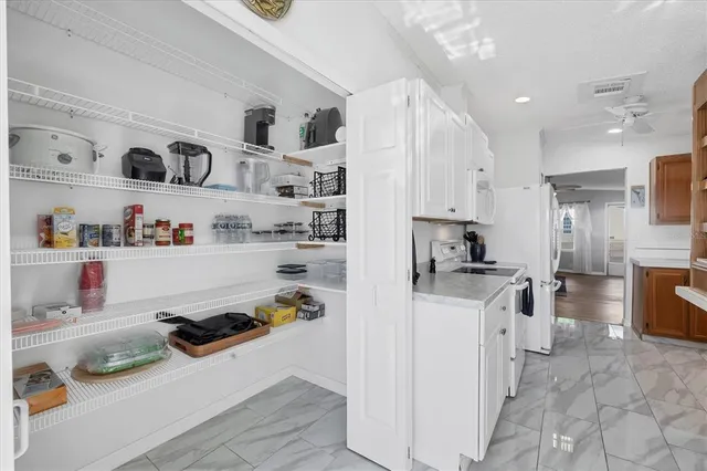 a kitchen with refrigerator and cabinets