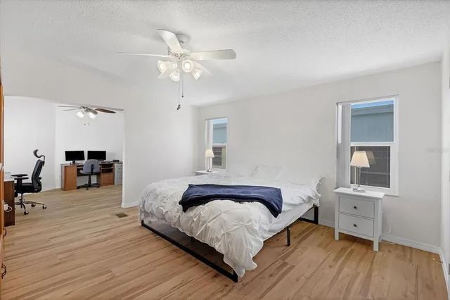 a spacious bedroom with a bed and a table in it