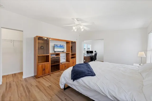 a large bedroom with a bed and a television