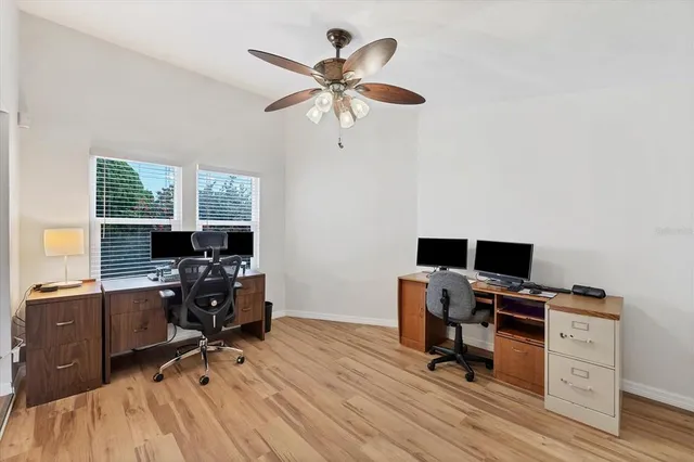 a view of a workspace with furniture and a window