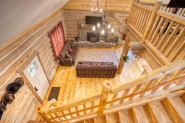 a view of a livingroom with wooden floor and a ceiling fan