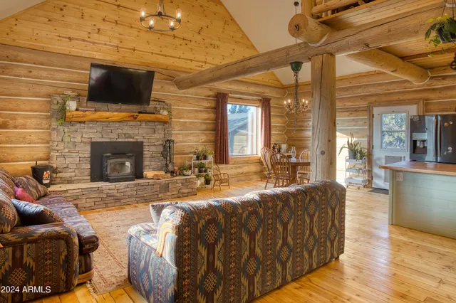 a living room with fireplace furniture and a flat screen tv