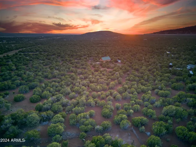a picture of a room with a white wall and a refrigerator