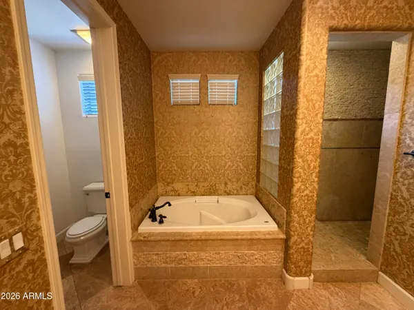 a bathroom with a tub and toilet