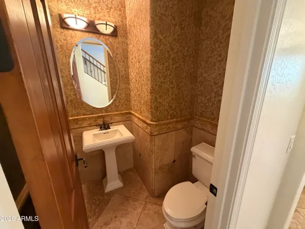 a bathroom with a sink a toilet and a mirror