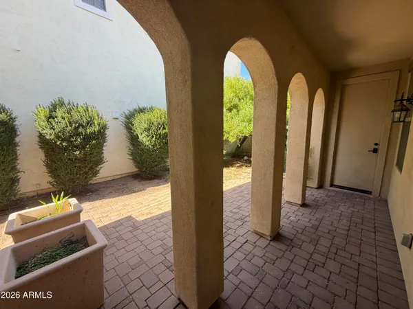 a view of front door with potted plants