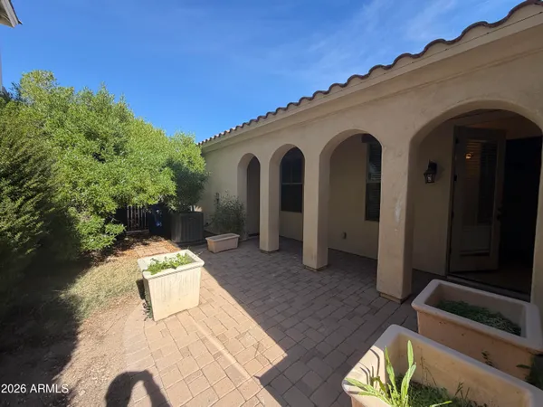a view of a house with backyard and sitting area