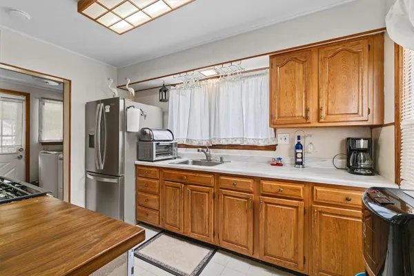 a kitchen with stainless steel appliances granite countertop a refrigerator and a sink