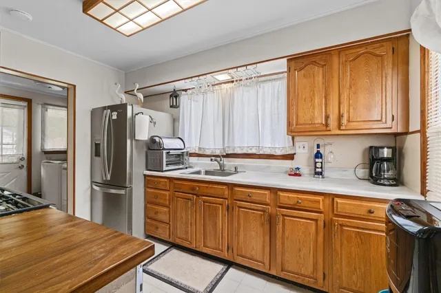a kitchen with stainless steel appliances granite countertop a refrigerator and a sink