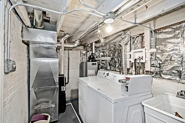 a utility room with a sink dryer and washer