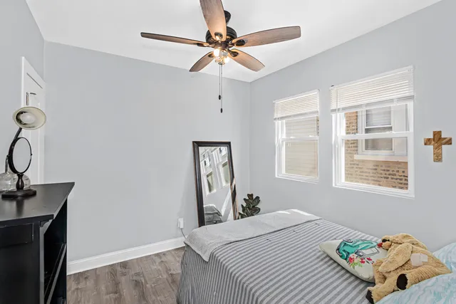 a bedroom with a bed dresser and a window