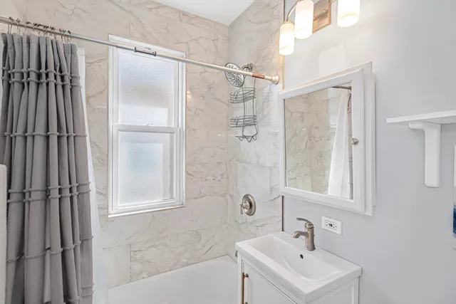 a bathroom with a sink a mirror and a shower