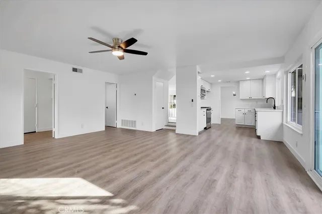 a view of a kitchen with wooden floor and a kitchen