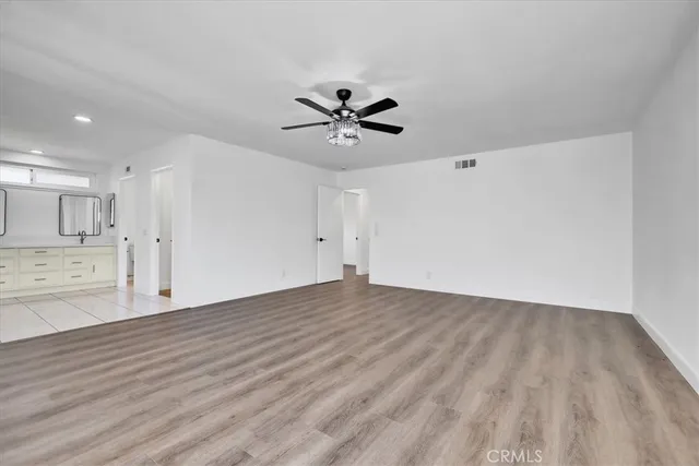 a view of a kitchen with wooden floor and a kitchen space