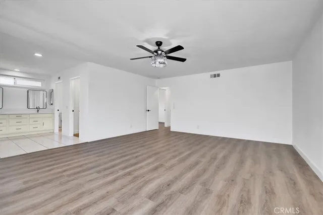 a view of a kitchen with wooden floor and a kitchen space