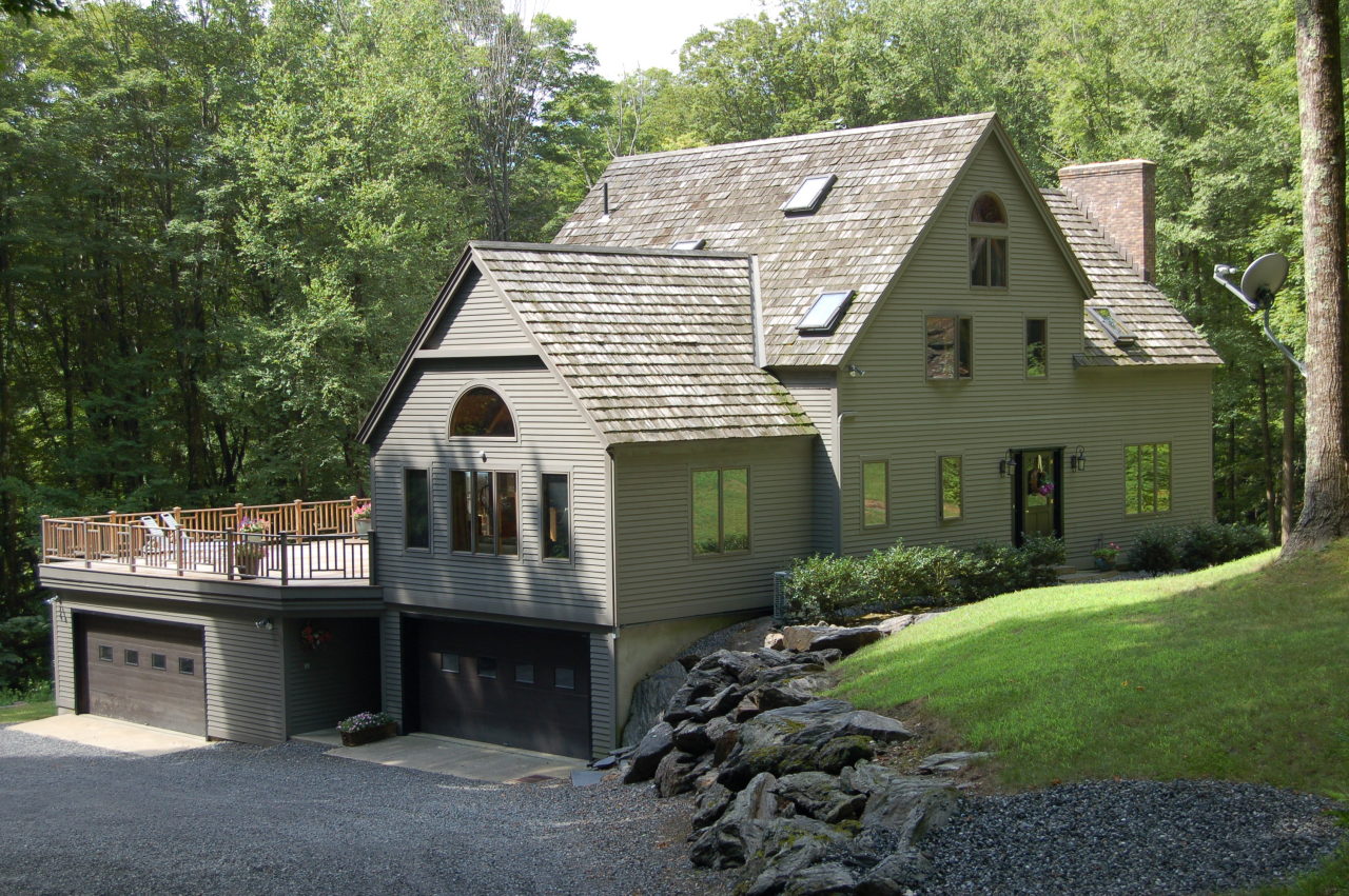 147 Reservoir Road Lenox, MA 01240 - Photo 1 of 31 a front view of a house with a garden and plants