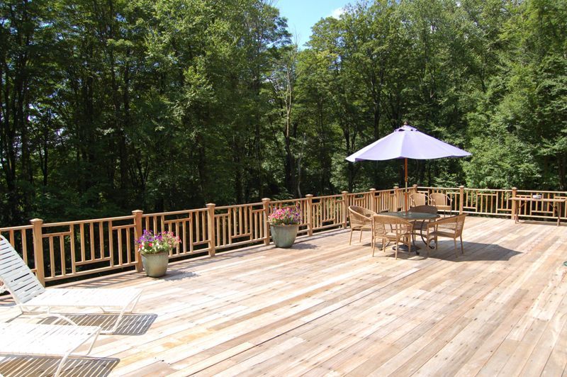 147 Reservoir Road Lenox, MA 01240 - Photo 22 of 31 a view of backyard with wooden fence and trees