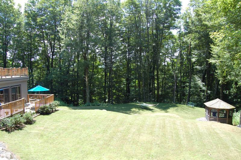 147 Reservoir Road Lenox, MA 01240 - Photo 29 of 31 a view of a chair and table in the backyard