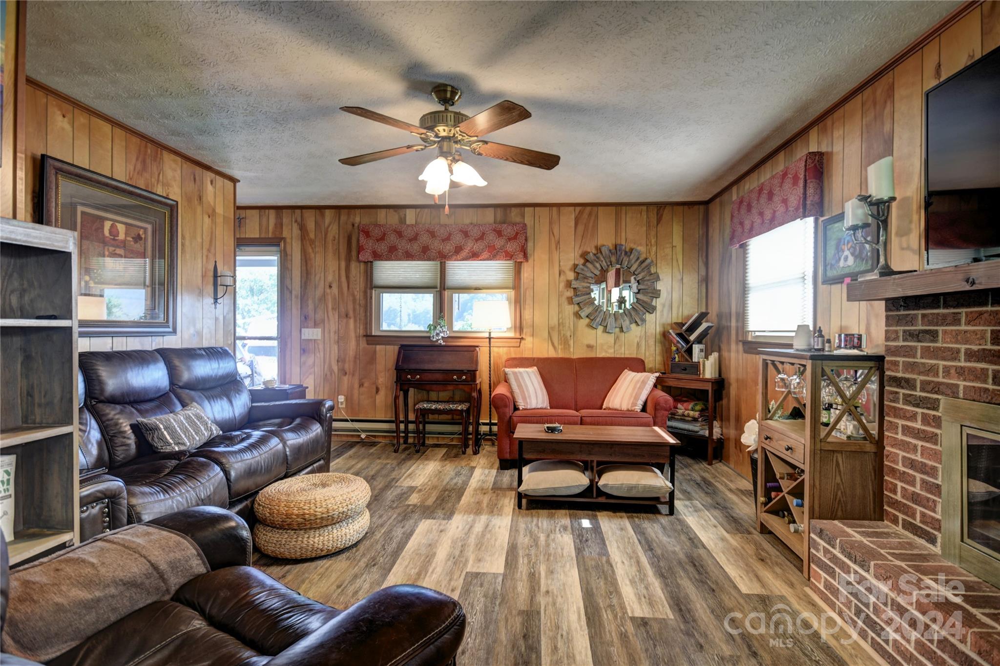 218 Raven Ridge Maggie Valley, NC 28751 - Photo 20 of 41 a living room with furniture a fireplace and a flat screen tv