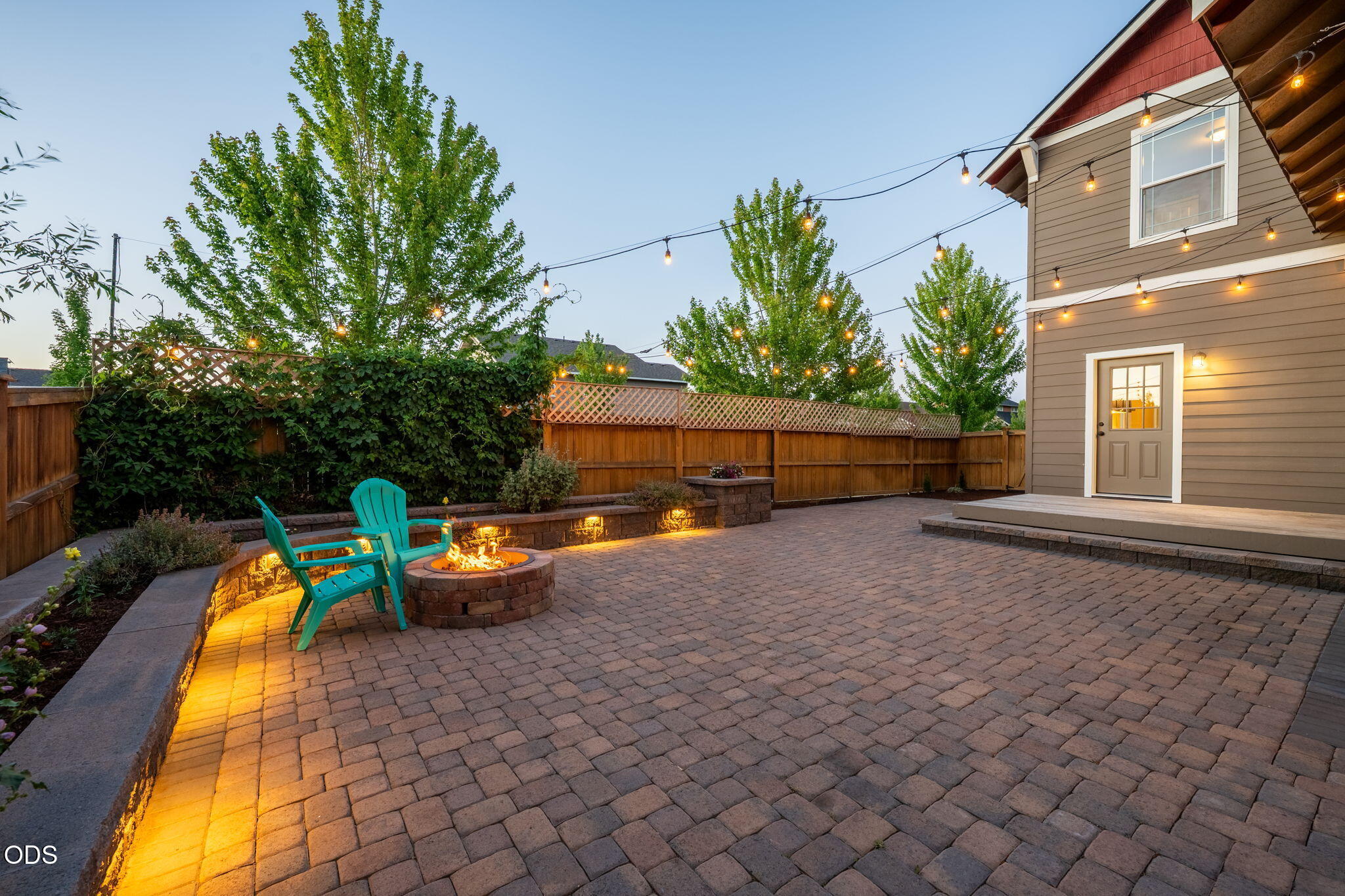62719 Hawkview Road Bend, OR 97701 - Photo 44 of 56 a backyard of a house with barbeque oven table and chairs