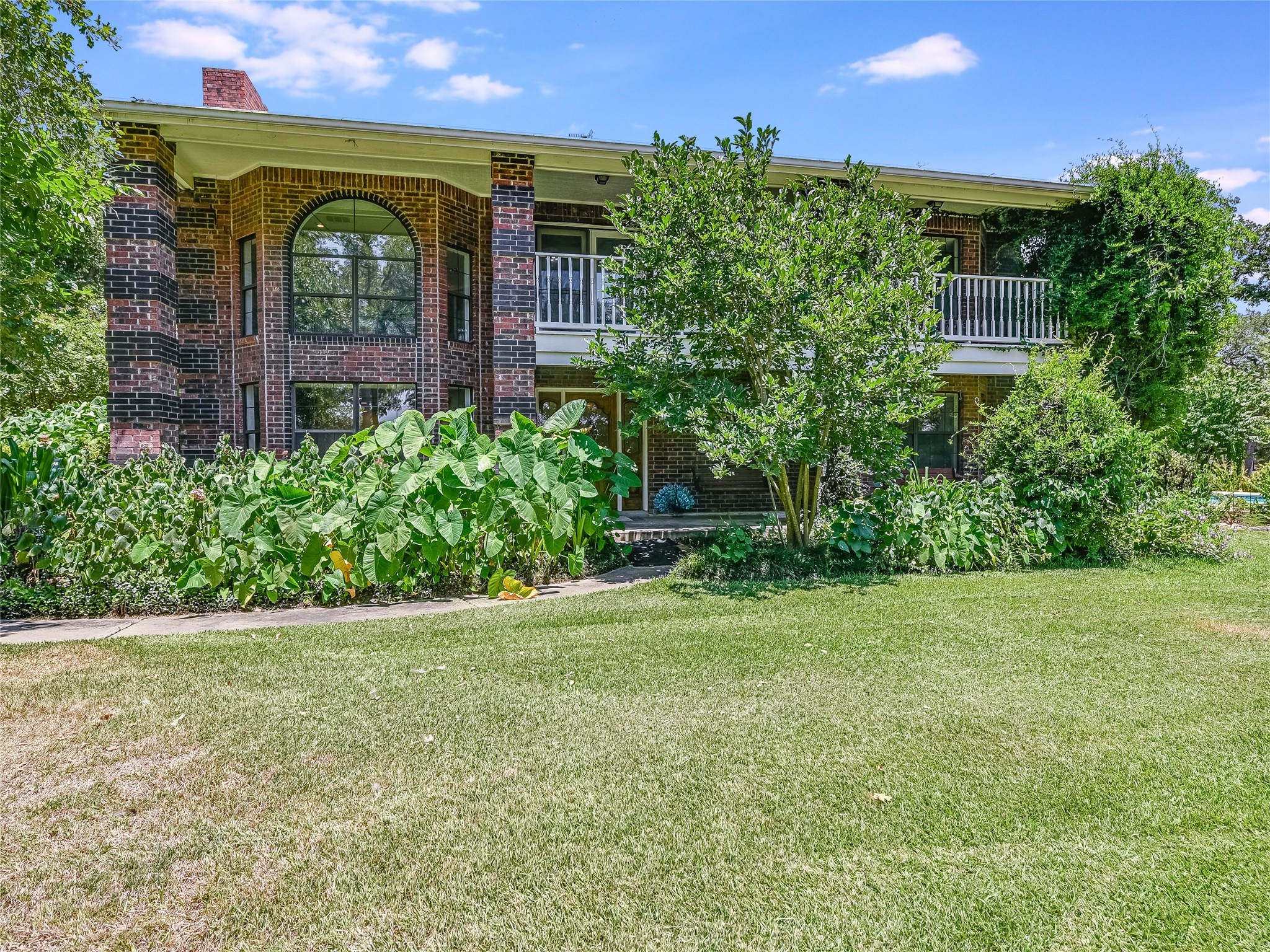 a front view of a house with garden