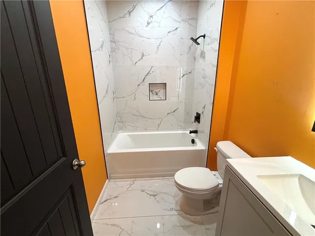 a bathroom with a toilet and a bathtub