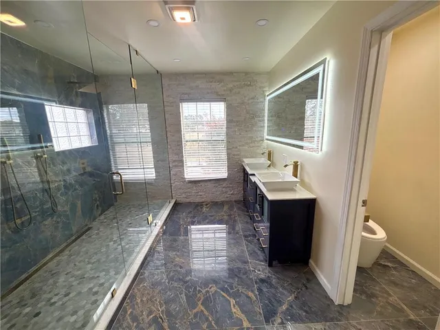 a bathroom with a sink vanity and mirror