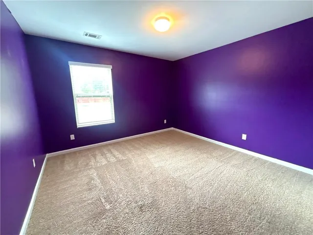 a bathroom with a granite countertop sink a toilet and a mirror