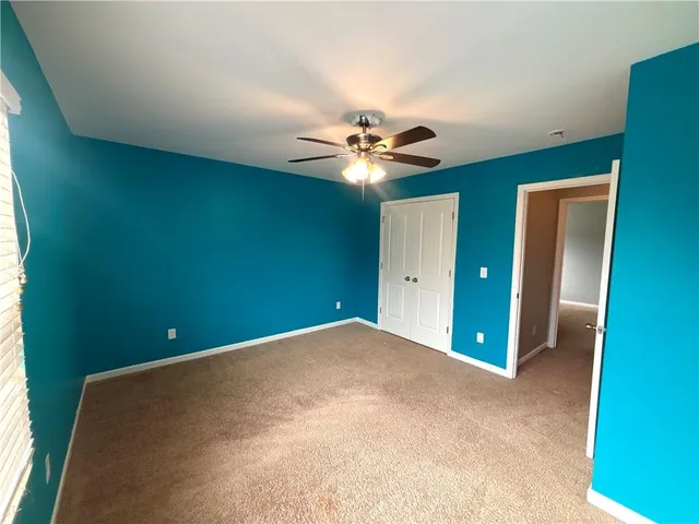 a view of backyard with wooden fence and large trees
