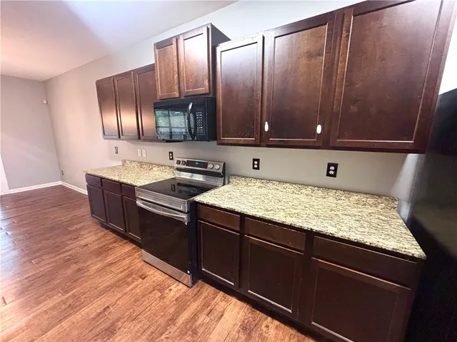a kitchen with wooden cabinets and a sink