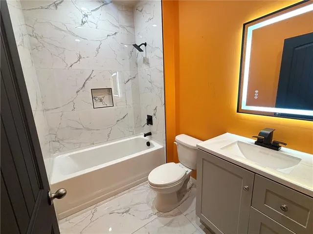 a bathroom with a sink toilet and shower