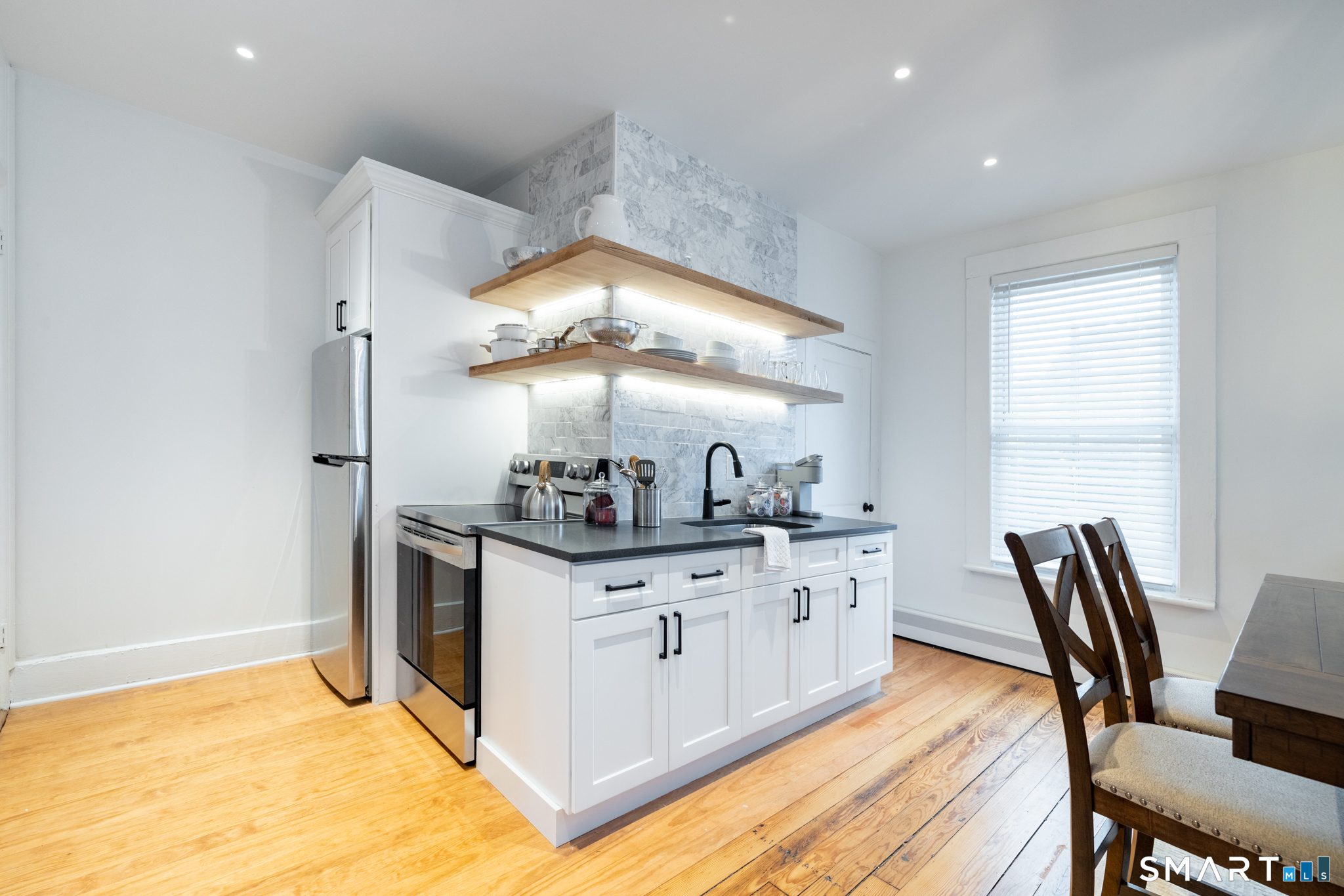 100 Center Street Southington, CT 06489 - Photo 11 of 19 a kitchen with stainless steel appliances granite countertop a stove and a refrigerator