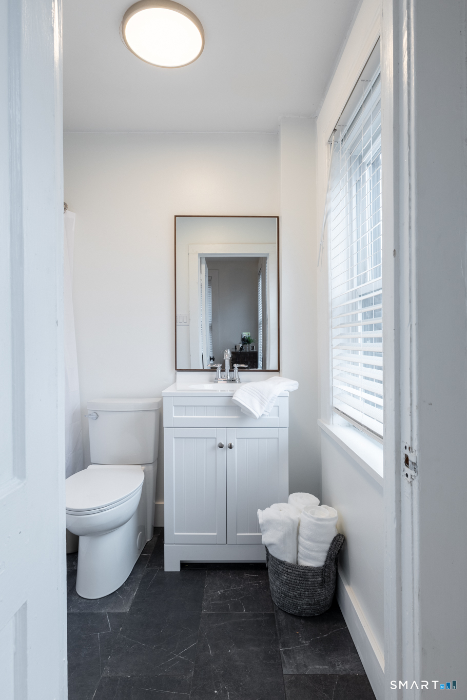100 Center Street Southington, CT 06489 - Photo 12 of 19 a bathroom with a toilet sink and mirror