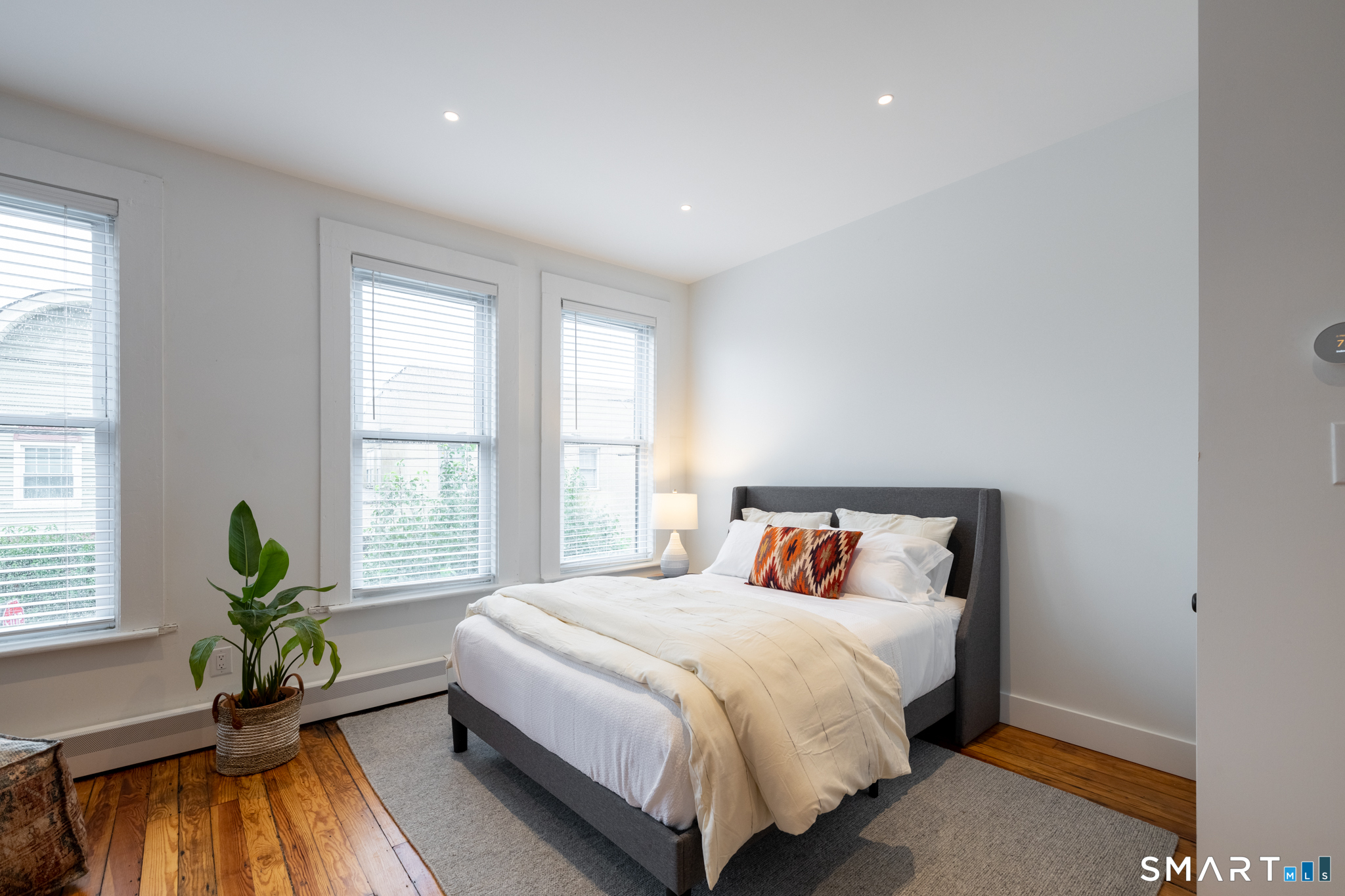 100 Center Street Southington, CT 06489 - Photo 5 of 19 a bedroom with a bed and windows