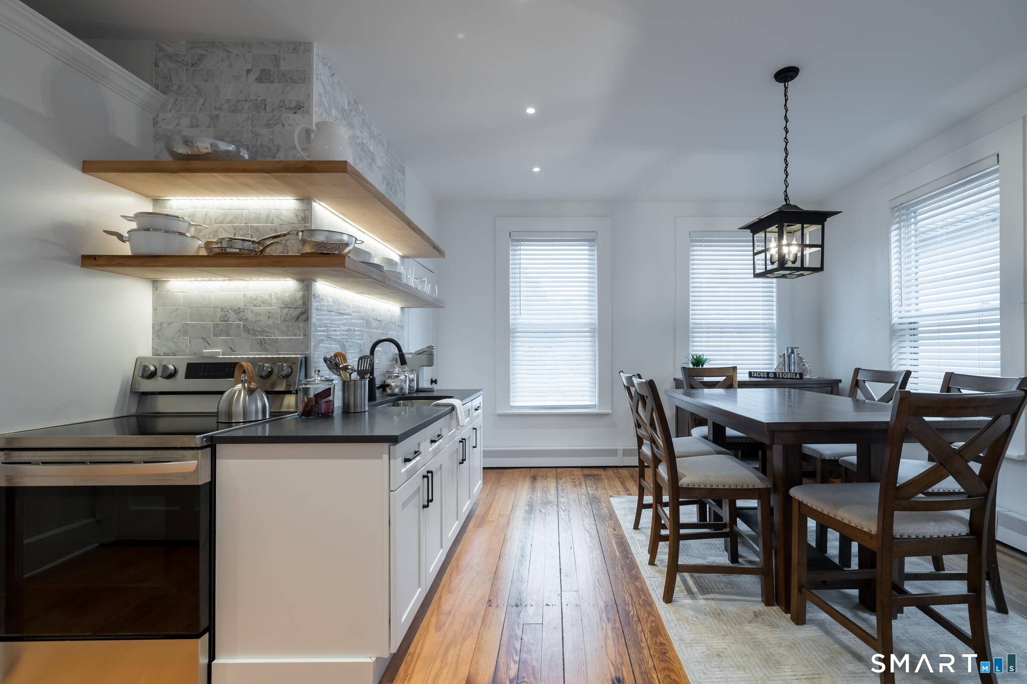100 Center Street Southington, CT 06489 - Photo 9 of 19 a kitchen with stainless steel appliances granite countertop a sink a stove and chairs
