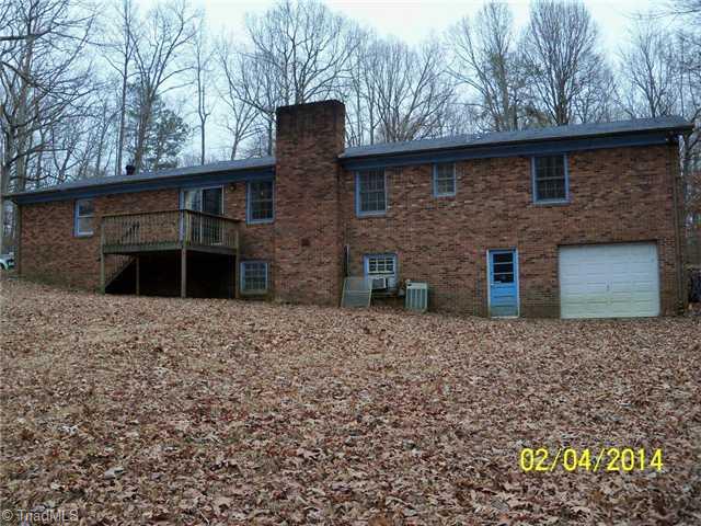 480 Rockett Road Randleman, NC 27317 - Photo 11 of 13 Exterior Back. Rear view showing deck and Single Garage located in unfinshed basement.