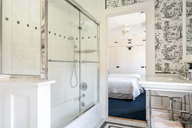 a bedroom with two beds and a chandelier