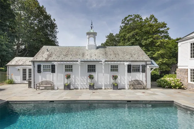 an aerial view of a house with swimming pool garden and patio