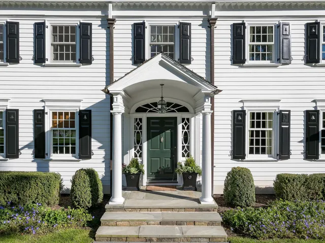 a front view of a house with a garden