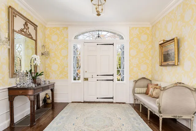 a view of a hallway with workspace and a window