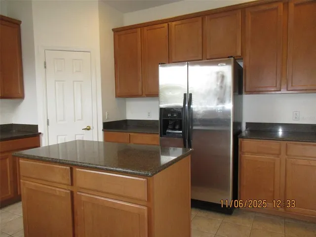 a kitchen with kitchen island a counter top space cabinets and a sink